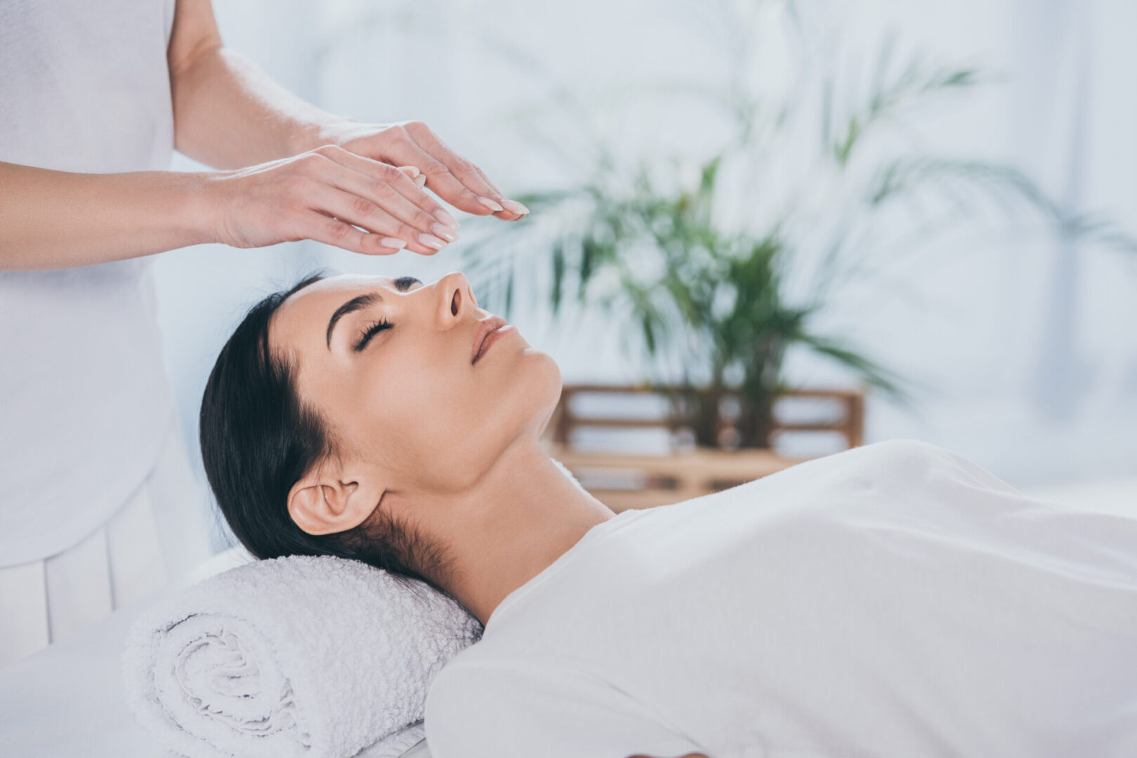 Woman receiving a relaxing Reiki healing session.