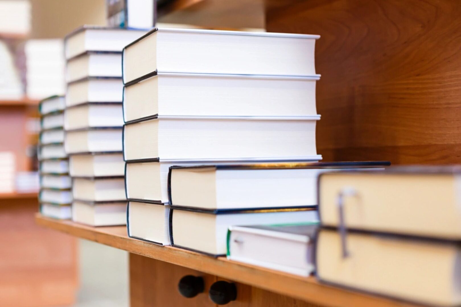 Stacks of books on wooden shelves.